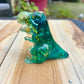 Figurine dinosaure bleu et feuilles d’or