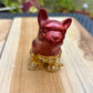 Figurine chien rouge et feuilles d’or